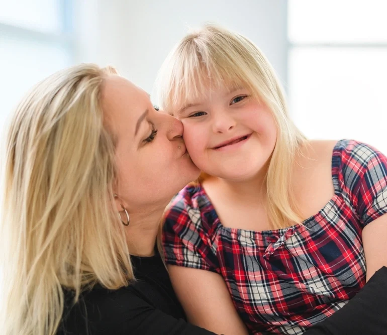 Disabled girl smiling with carer