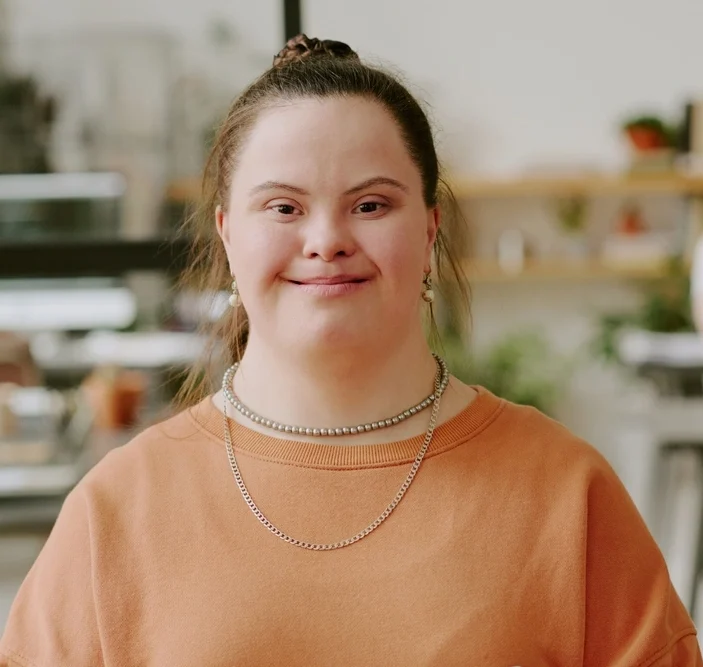 Disabled woman with down syndrome smiling at camera